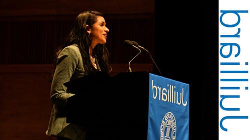 Woman speaking at a podium